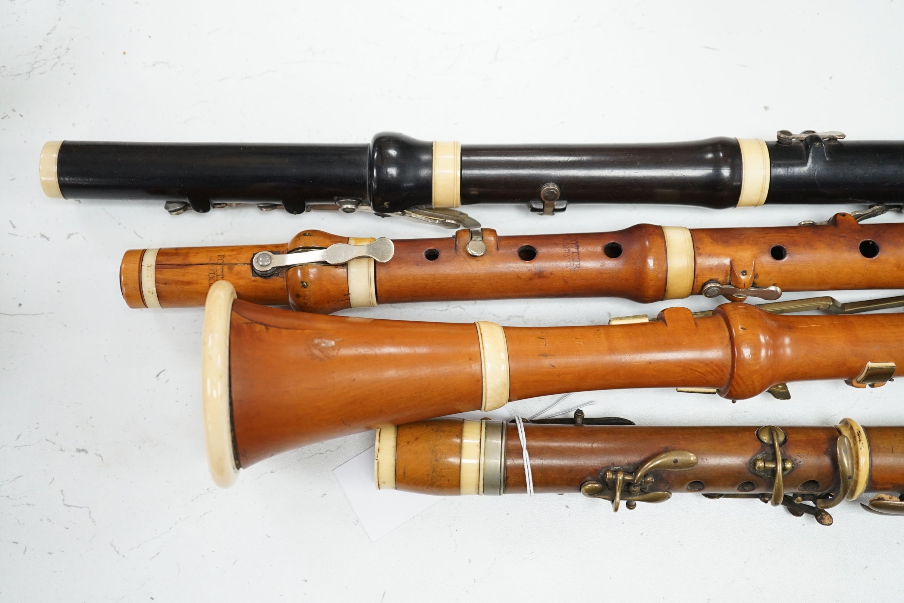 Two 19th century flutes by W. Potter, one in boxwood, the other ebony, and two 19th century boxwood clarinets, one by Dollard, the other by Lazarus